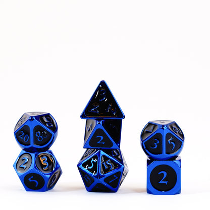 Metallic blue polyhedral dice with black numbers are neatly stacked in three groups on a white background.