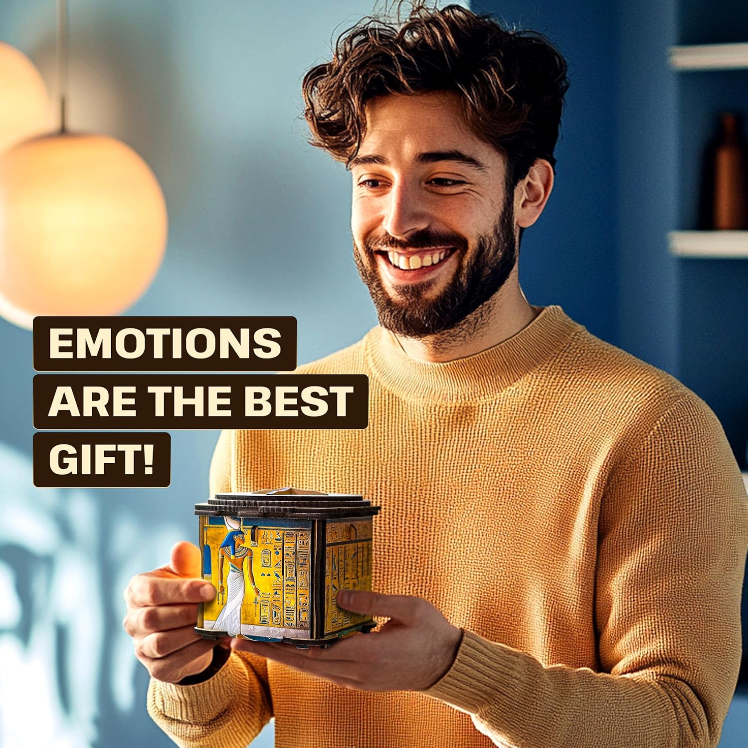 A smiling man holds an elaborate Egyptian-themed puzzle box.