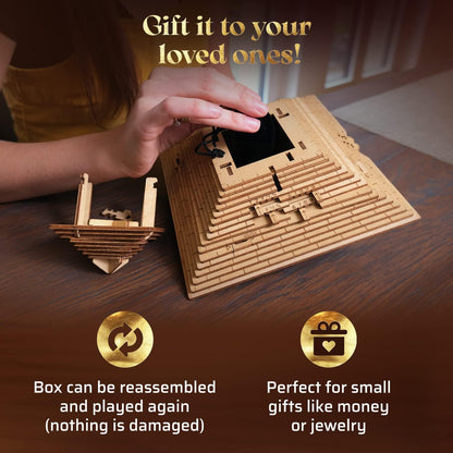 A hand interacts with a wooden pyramid puzzle gift box, revealing a black pouch inside its numbered layers. Another wooden puzzle piece nearby