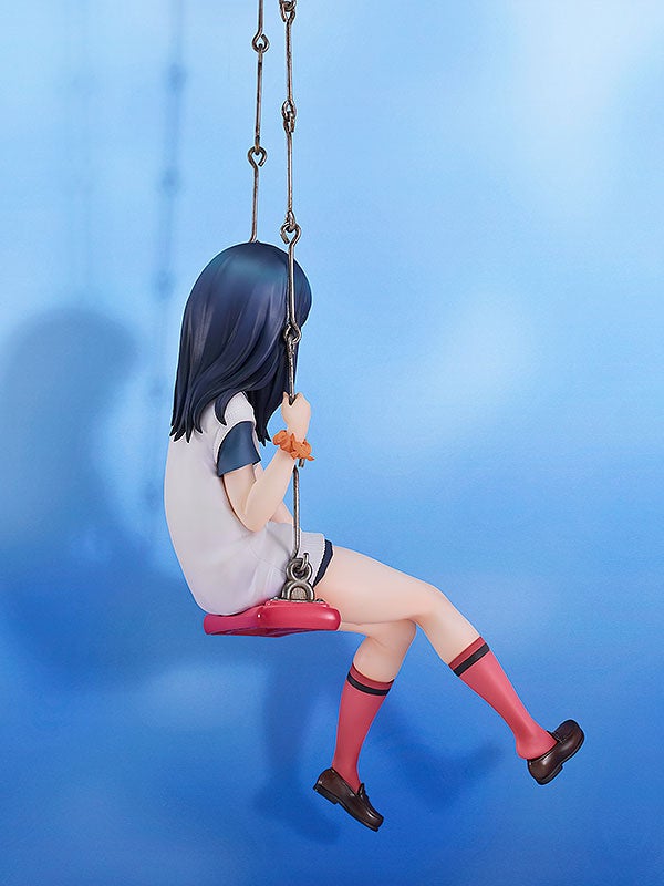 Anime figure of a girl with dark blue hair and red socks on a red swing