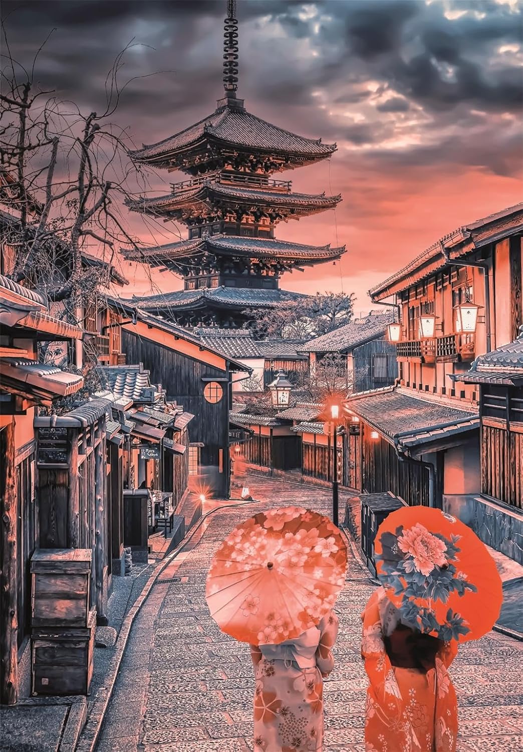 Two people in kimonos with patterned parasols walk up a stone street towards Kyoto's Yasaka Pagoda under an orange sunset.