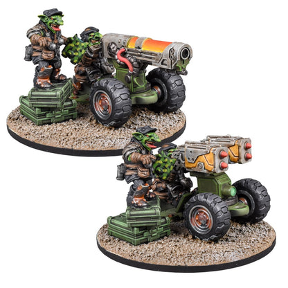 Two green-skinned goblin miniatures. One crews a large cannon, the other a twin rocket launcher