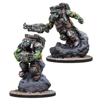 Two armored, green-skinned sci-fi miniatures. One leaps with jetpack & gun from a rock; the other stands holding a gun