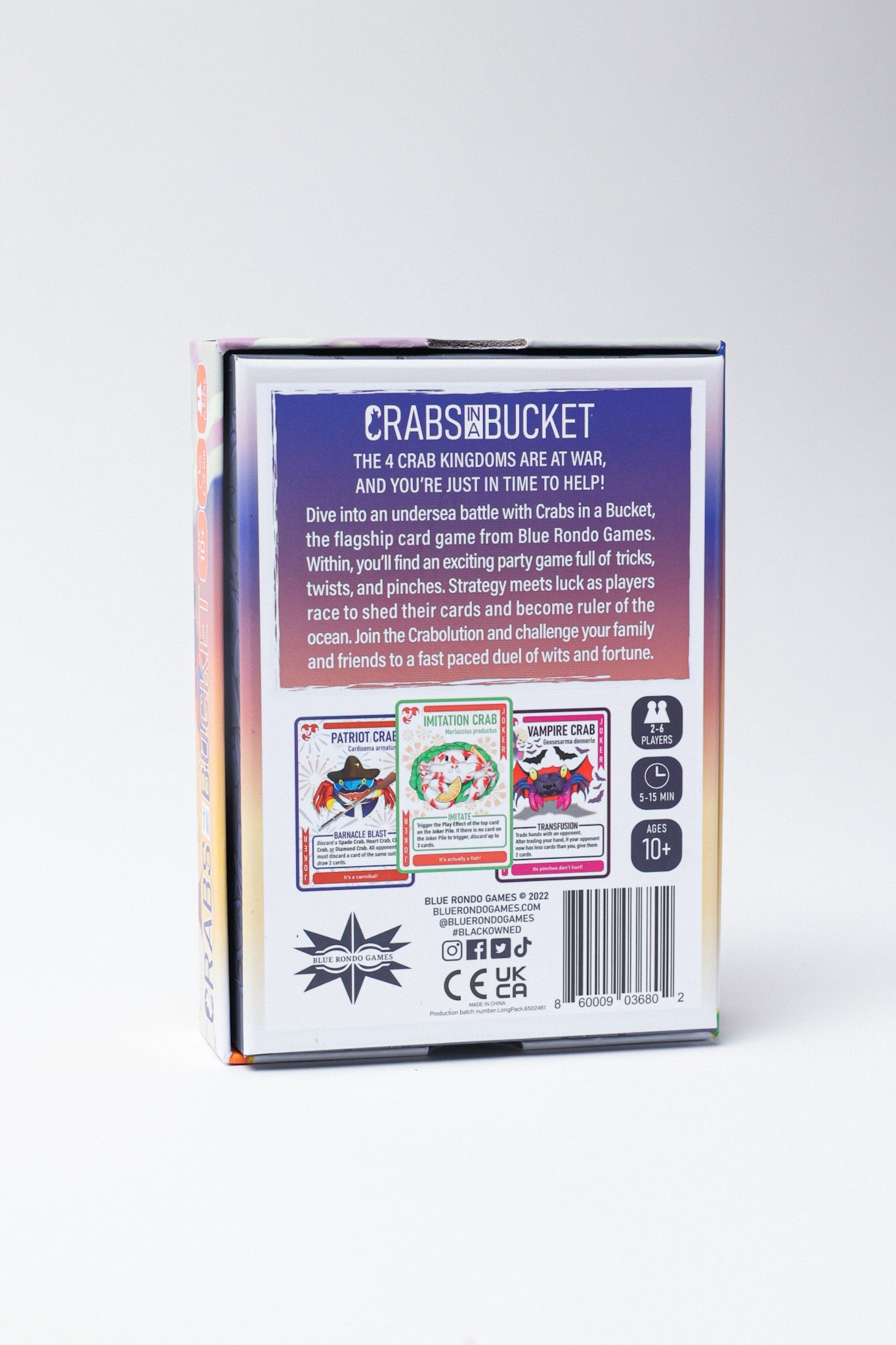 Back of Crabs in a Bucket board game box with a blue panel displaying the title, game description, player info, and sample cards