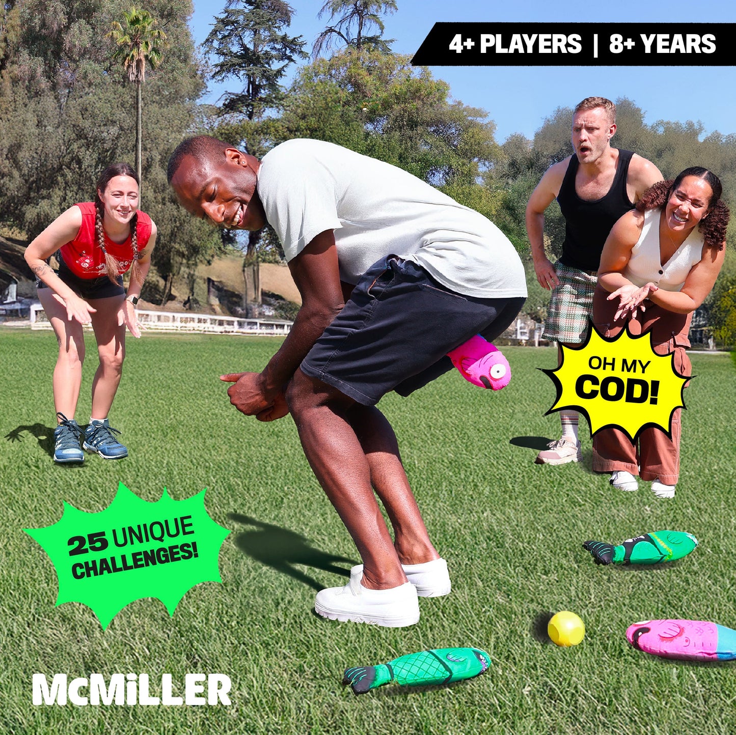 Four players on green grass playing McMiller Fish Fight a party game featuring a man with a pink fish plushie at his backside and green fish plushies on the ground