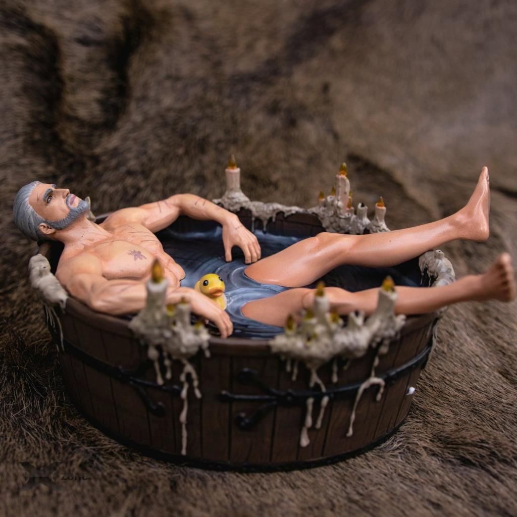 Geralt of Rivia figurine relaxing in a wooden tub with a rubber duck and melted candles