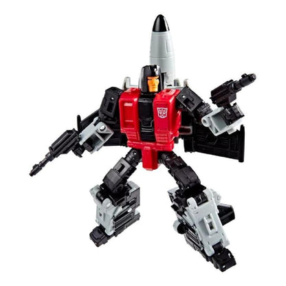 Black and red Transformer robot toy holding dual blasters, featuring a large gray rocket attached to its back