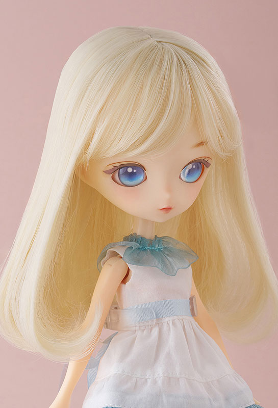 Curious doll holding a plush animal, showcasing her coordinated shoes and accessories