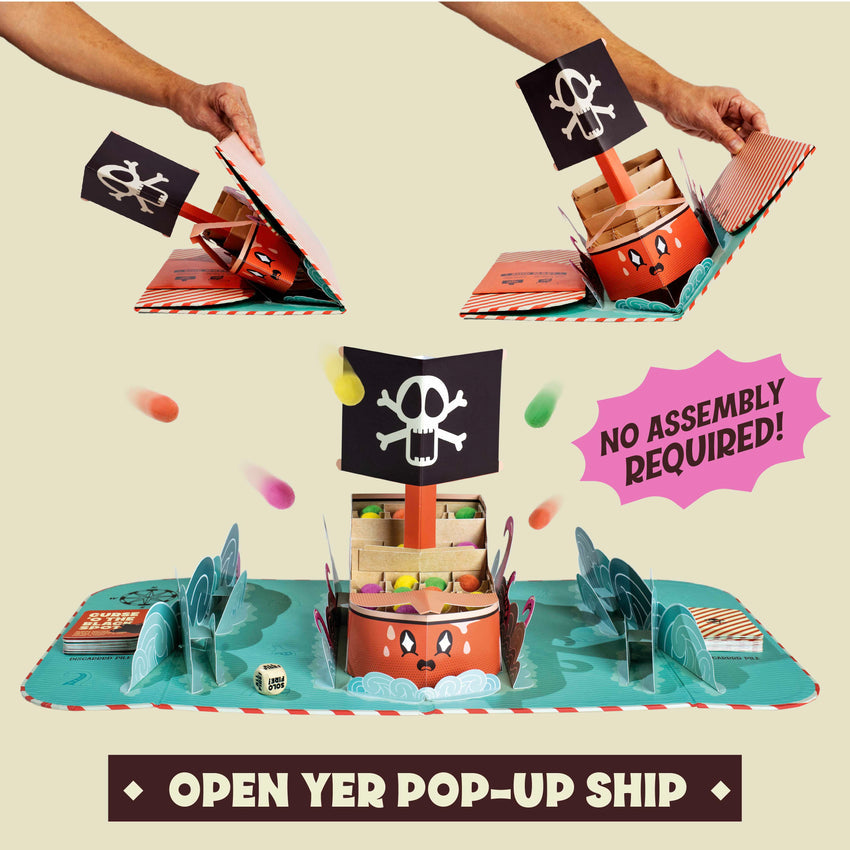 A colorful pop-up pirate ship game unfolds from a book into a 3D game board with a skull and crossbones flag.