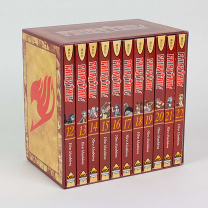A Fairy Tail manga box set: 11 red-spined volumes (12-22) with character art are held in a golden box with a large red logo.