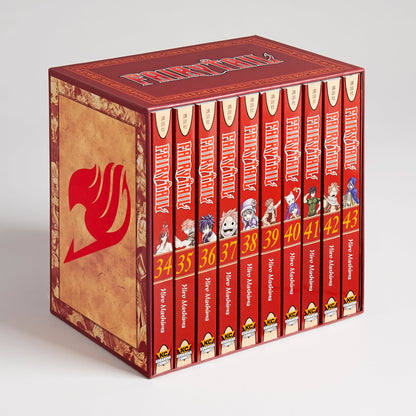 A reddish-brown Fairy Tail manga box set containing ten red volumes (34-43). The box features a large red guild logo.