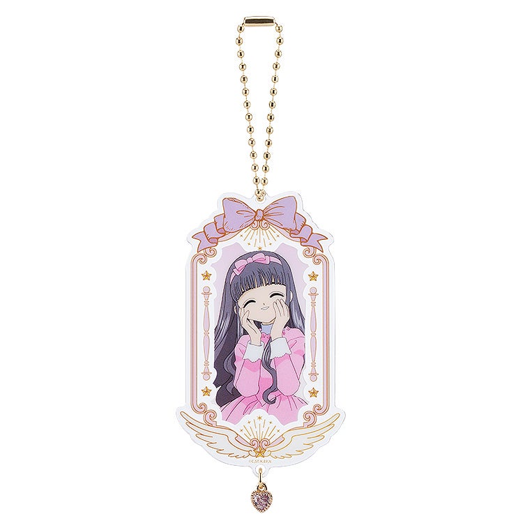 Cardcaptor Sakura 25th Anniversary Kero acrylic keychain featuring a smiling Sakura in a pink dress with a purple bow and pink heart charm
