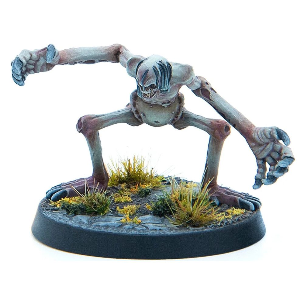 A pale, emaciated monster miniature with long limbs and clawed hands crouches on a grassy base, reaching forward