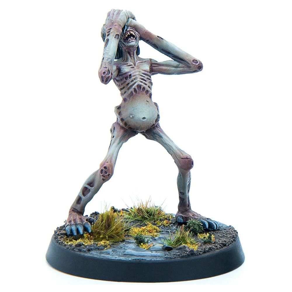 An emaciated, pale ghoul miniature with exposed ribs and distended belly, screaming while clutching its head