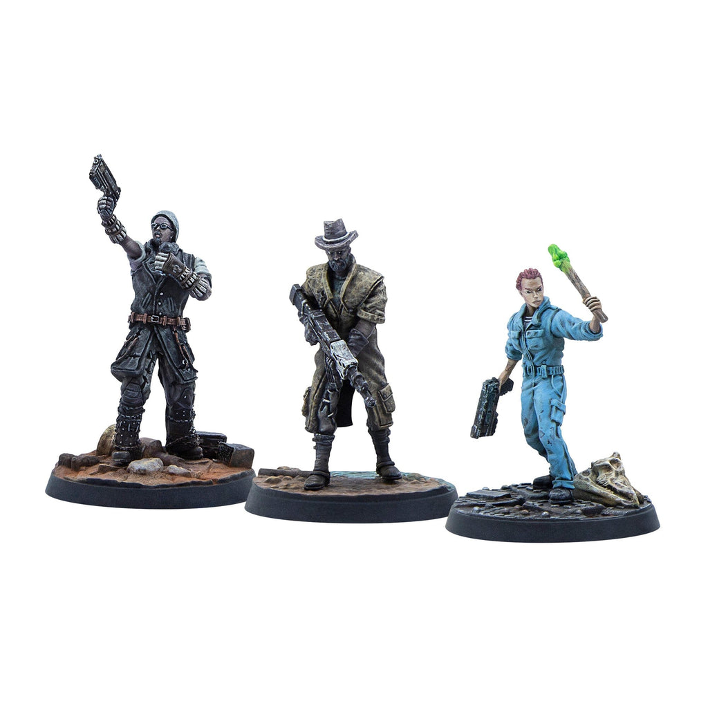 Three painted post-apocalyptic miniature figures: one raising a pistol, one holding a rifle, and one with a glowing green torch.