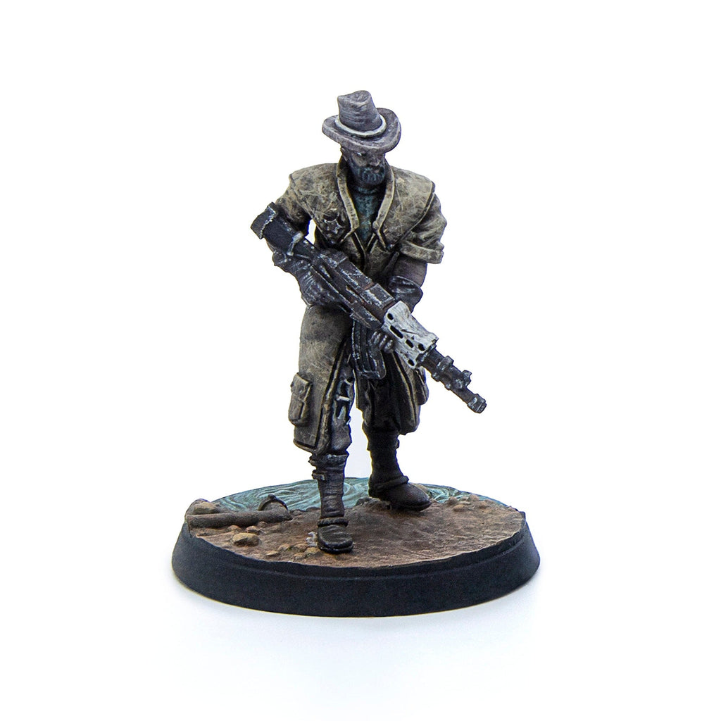 Painted miniature of a grim figure in a duster coat and hat, holding an assault rifle with a skull-like muzzle