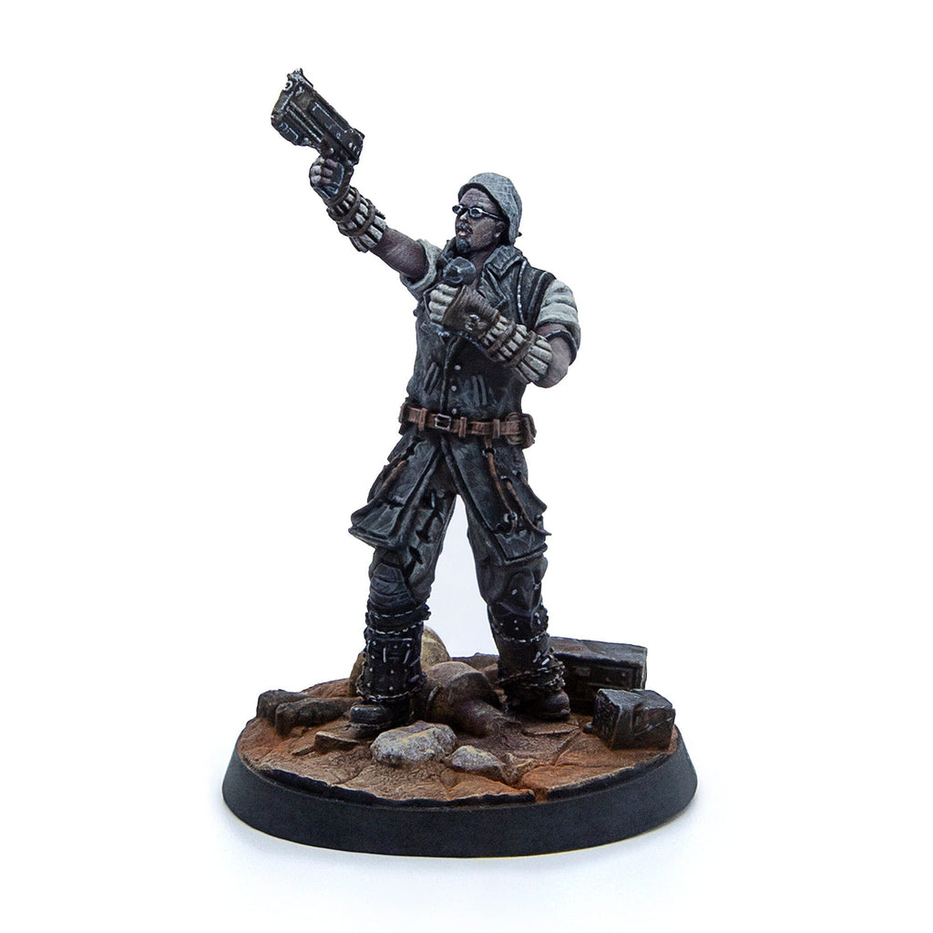 A painted miniature of a rugged figure in a beanie and glasses, raising a pistol. Stands on a debris-strewn base