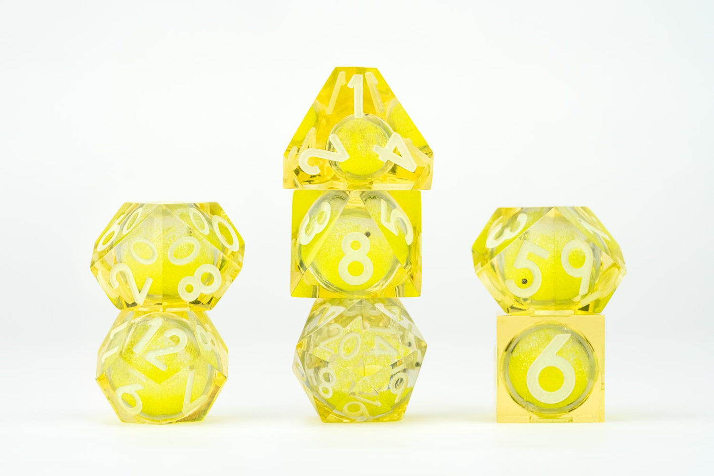All included dice in Shadow Light UV Reactive Elixir Liquid Core RPG Dice Set