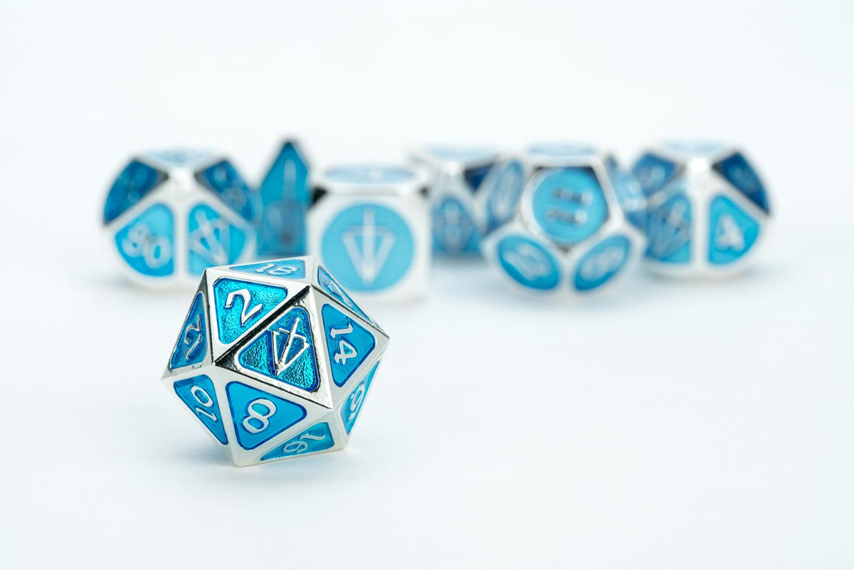 FanRoll metal dice set for Tales of the Valiant shown with packaging and accessories