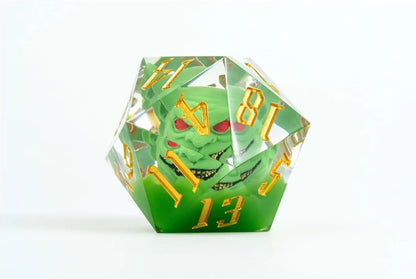 Clear green d20 dice with a snarling green goblin head (red eyes) inside and gold numbers