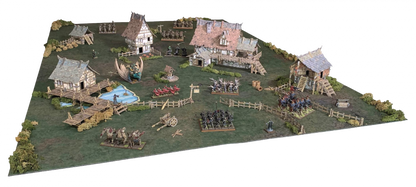 A detailed miniature wargame battlefield featuring fantasy armies, medieval buildings, a pond, and a large dragon.