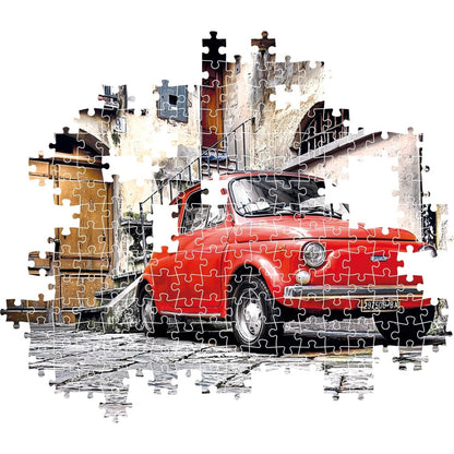 A jigsaw puzzle showing a red vintage car parked on a cobbled street against old buildings.