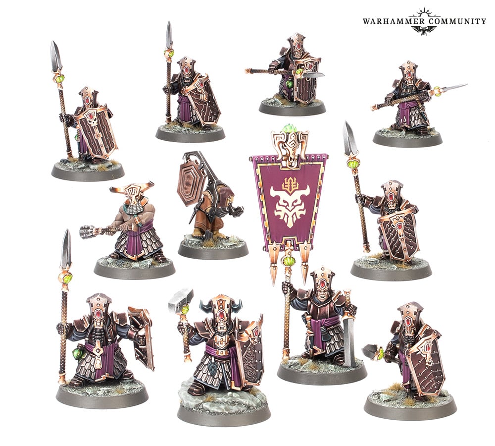 A unit of 11 heavily armored Duardin (dwarf-like) miniatures with spears, shields, hammers, and a banner
