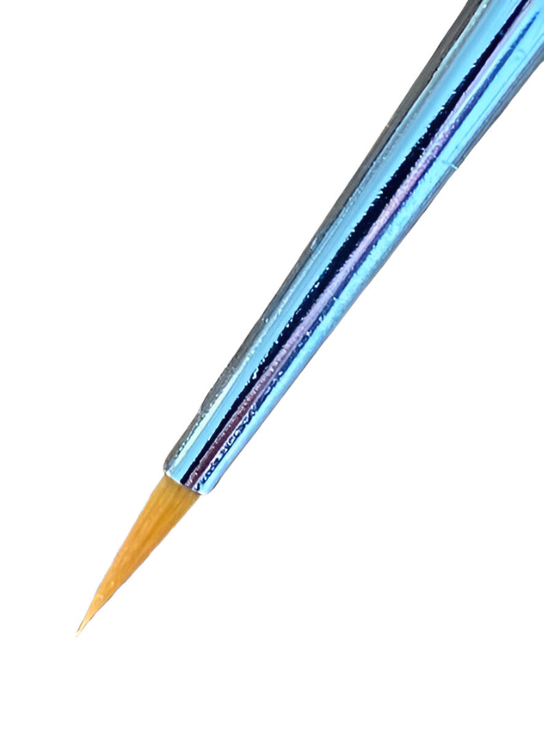 Ultra-fine tipped brush with light brown bristles and a reflective blue handle, angled down against a white background