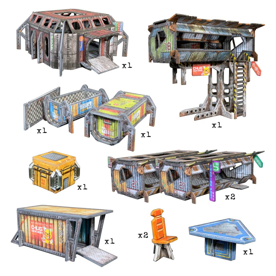 Nine modular, weathered cyberpunk terrain pieces: multi-story buildings, containers, a raised shop, trading post, chair, and table.