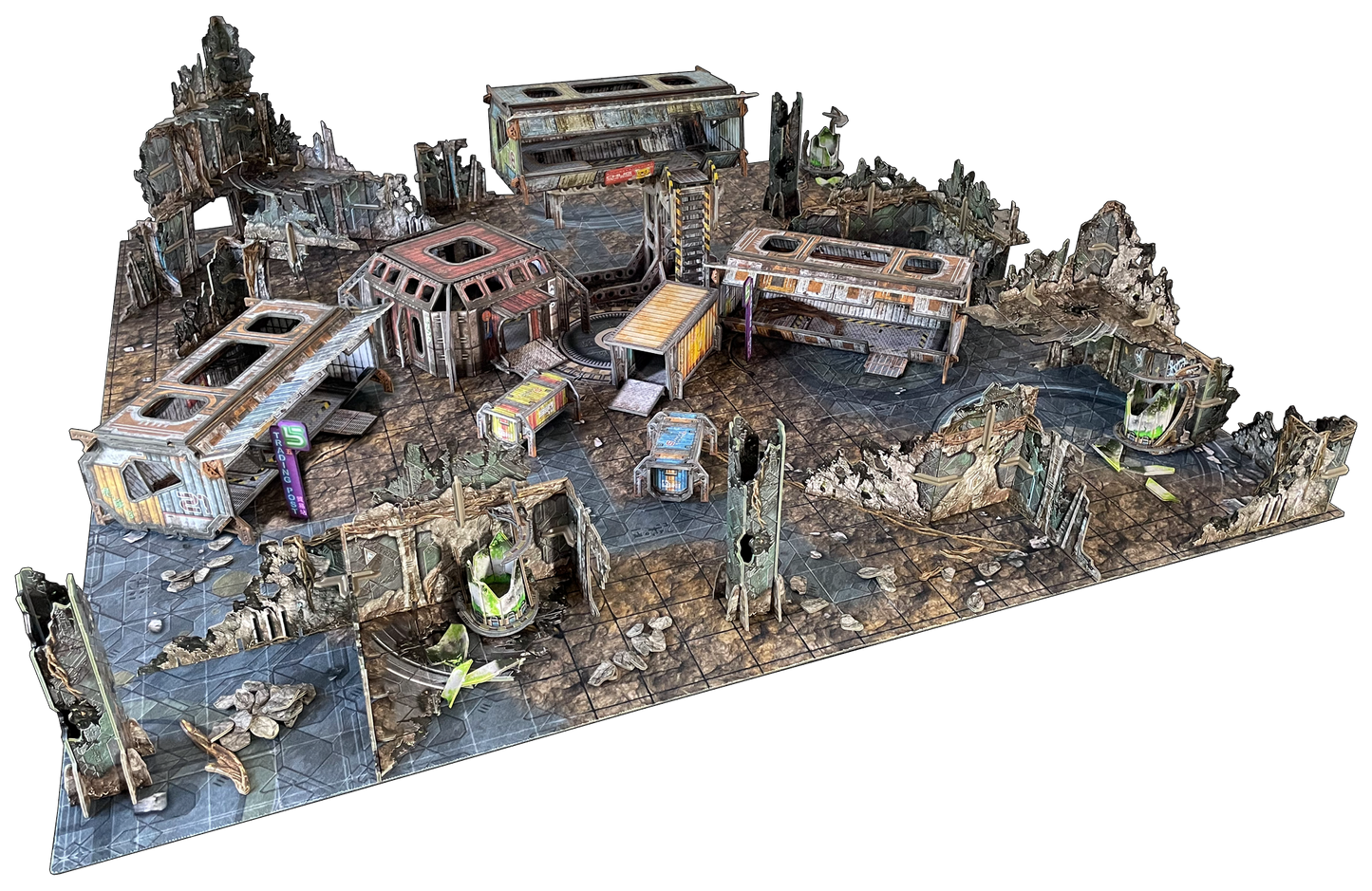 Modular tabletop wargaming terrain set depicting a multi-level, ruined industrial city with damaged buildings and debris.