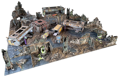 Modular tabletop wargaming terrain set depicting a multi-level, ruined industrial city with damaged buildings and debris.