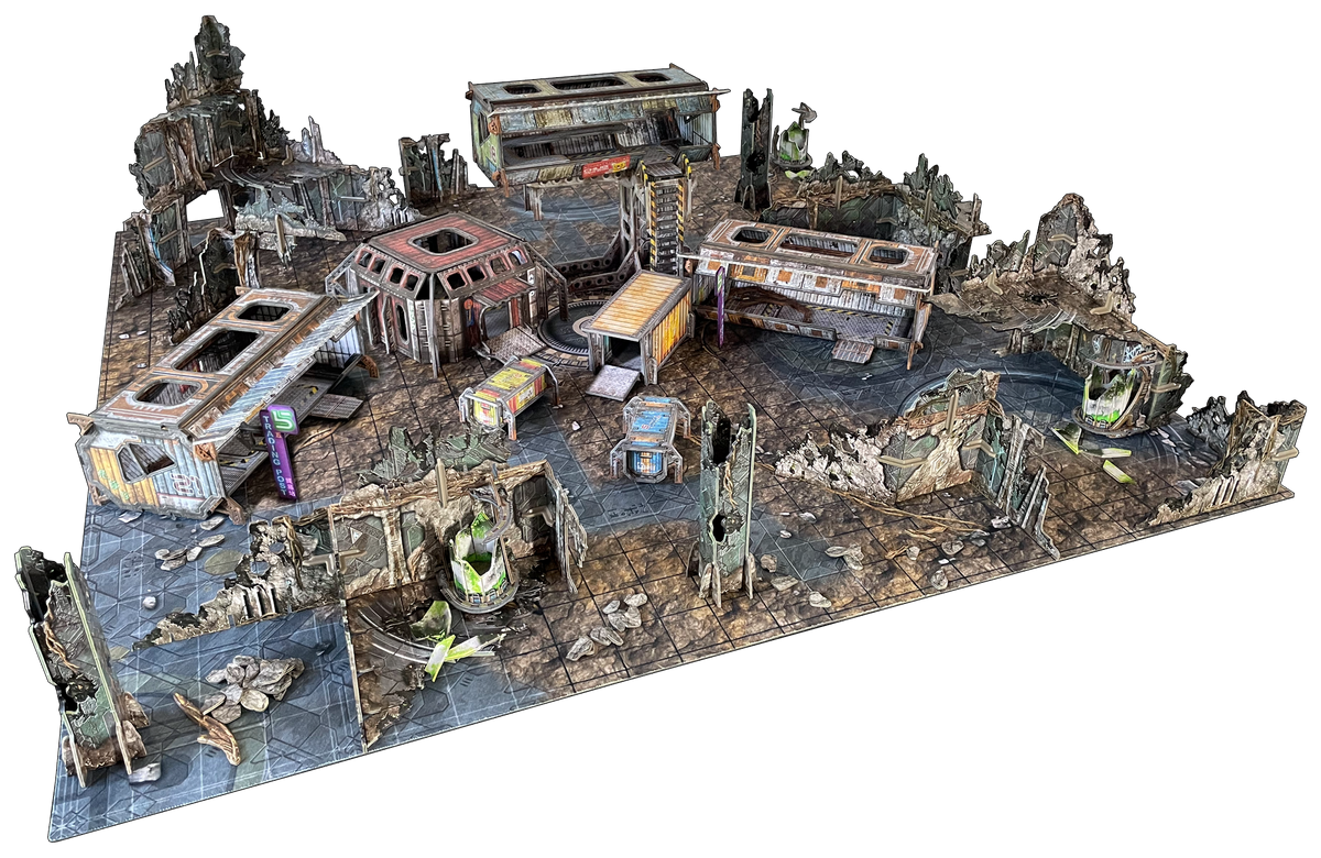 Modular tabletop wargaming terrain set depicting a multi-level, ruined industrial city with damaged buildings and debris.