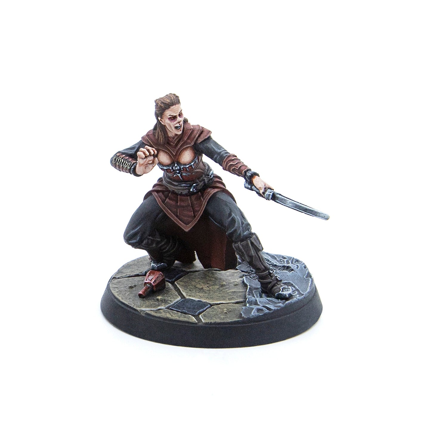 Miniature of an aggressive female warrior with fangs and red eye markings, crouching with a sword and extended hand