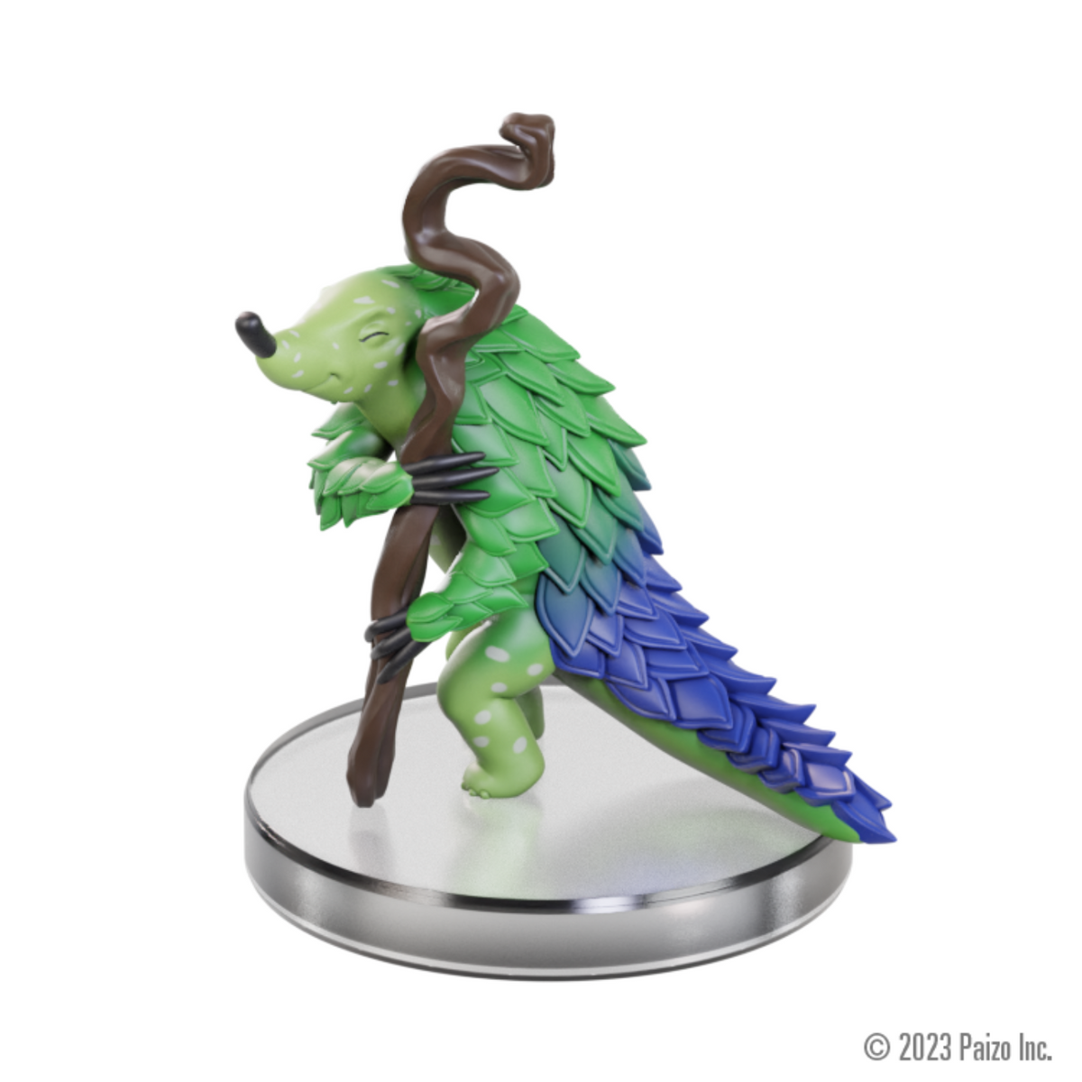 A green pangolin-like figure with leaf-like scales and a blue tail, leaning on a staff