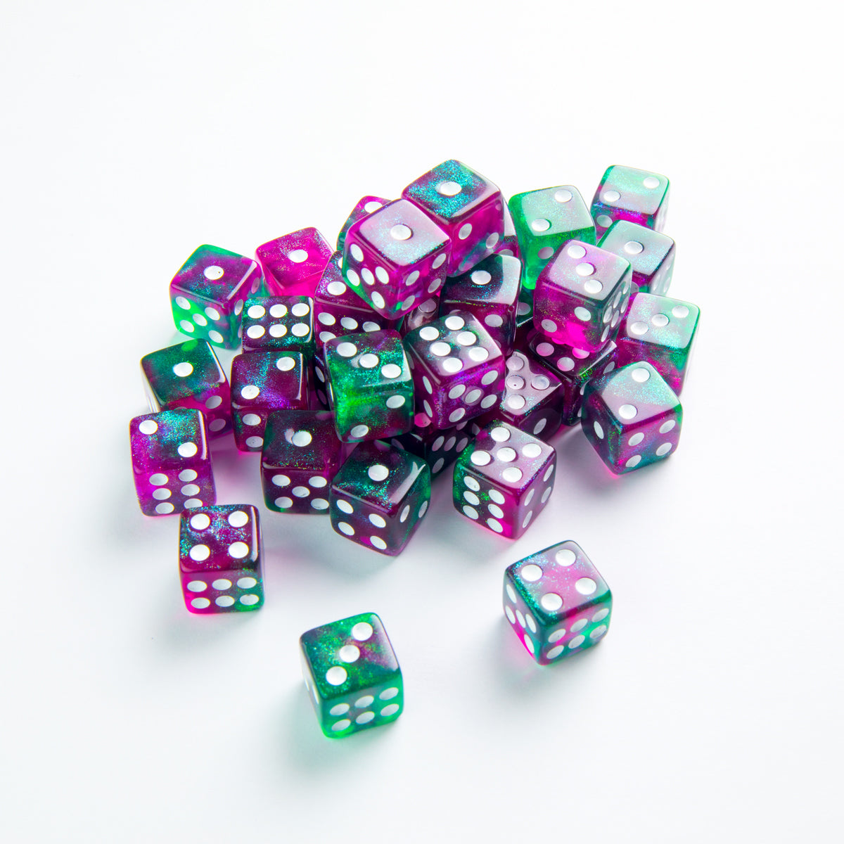 Gamegenic Galaxy Series Aurora 12mm D6 dice set translucent fuchsia and green glitter resin with white pips scattered pile on white background