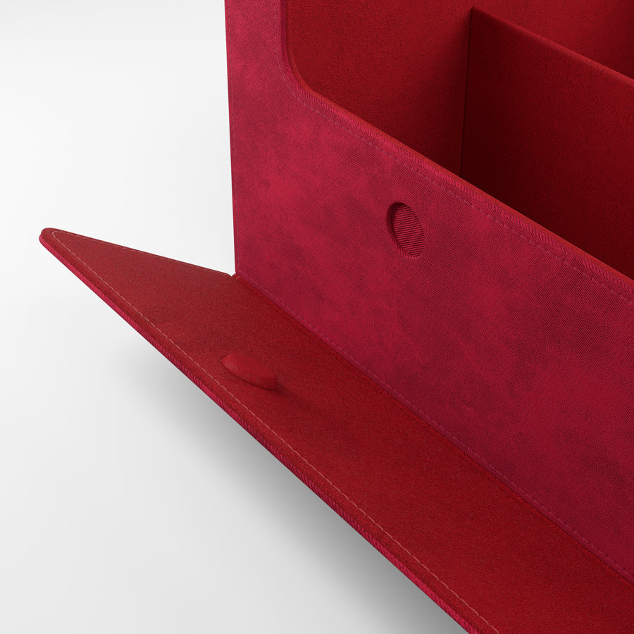 A deep red fabric file organizer with an open flap, showing internal dividers and a fabric button closure