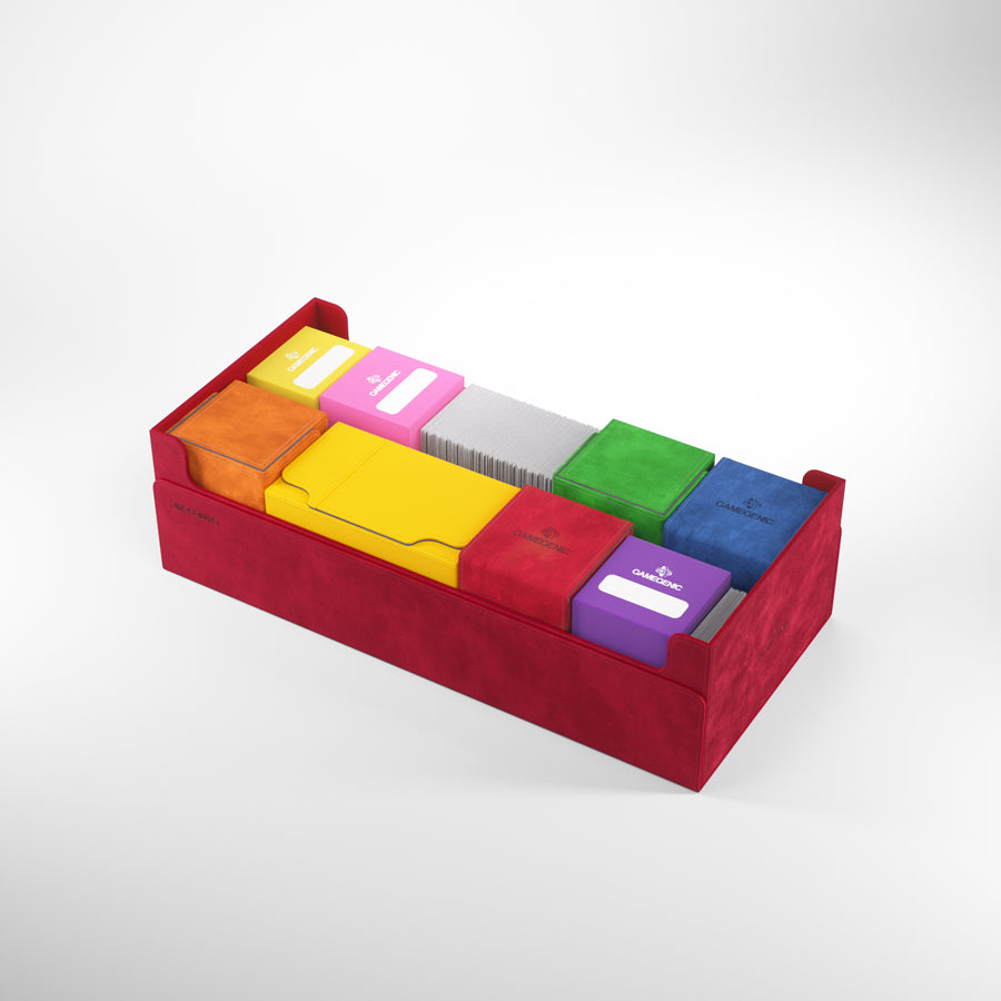 A red card organizer box holds colorful Gamegenic deck boxes and stacks of white cards