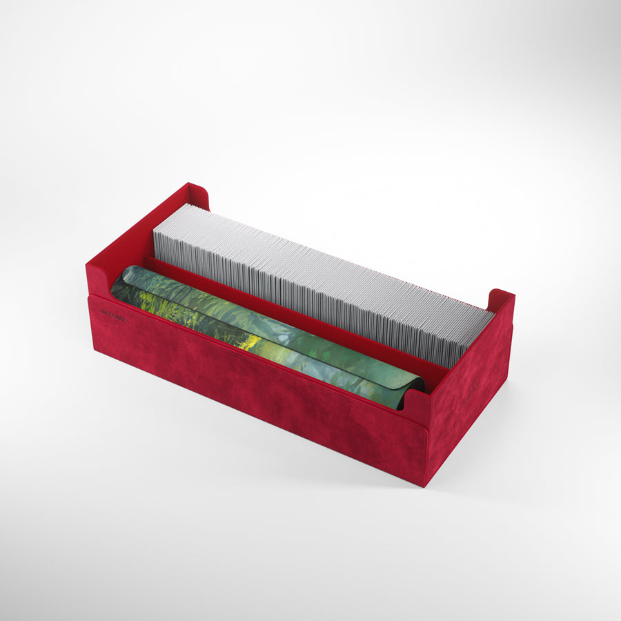 Red velvet storage box with a long row of white playing cards and a rolled-up forest-themed playmat