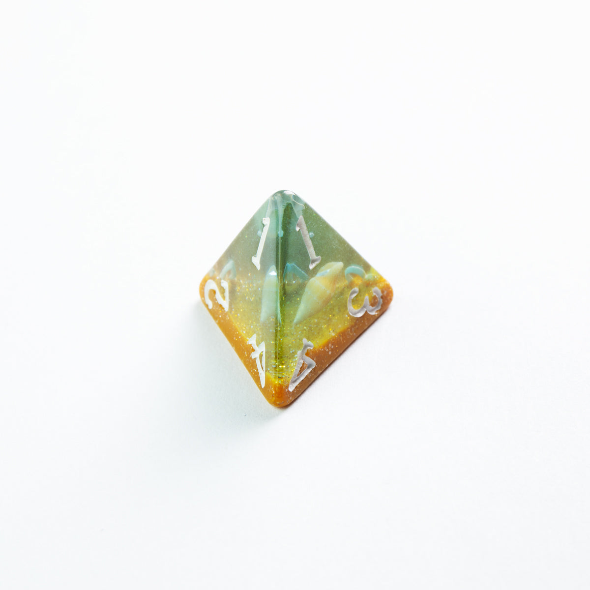 Resin D4 roleplaying die, green and orange gradient with glitter, resting on white