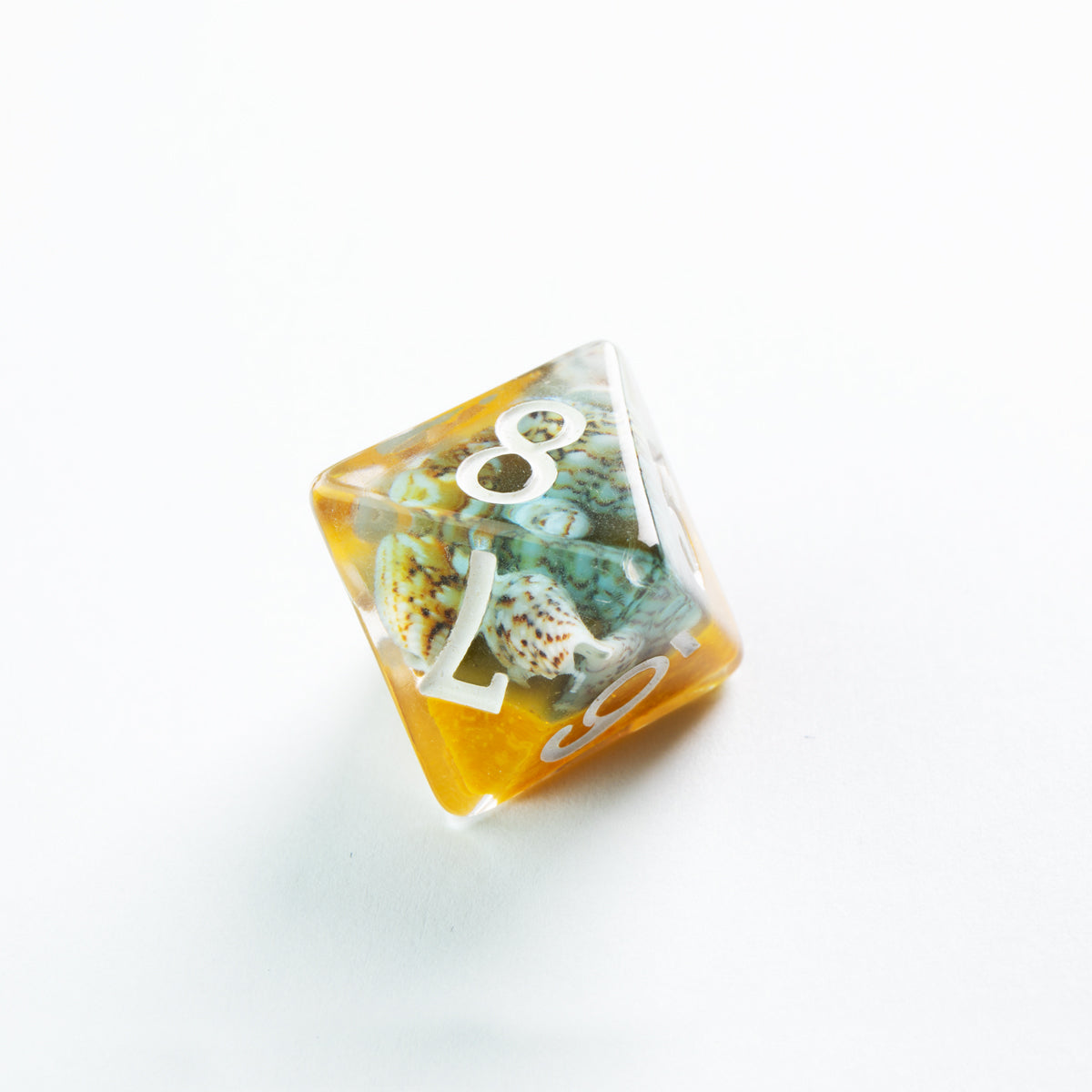 Amber and clear resin D20 die embedded with small seashells