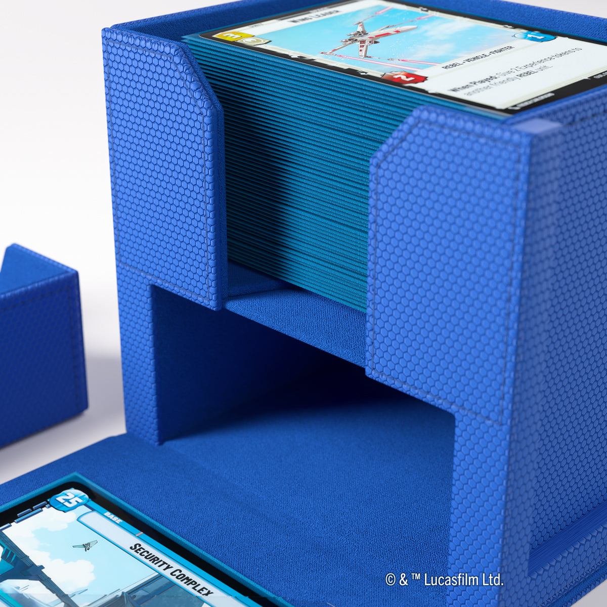 A blue hexagonal deck box holding a stack of blue-sleeved Star Wars game cards 