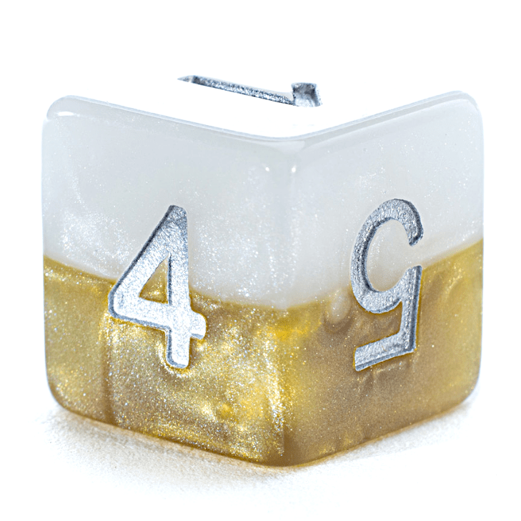 A pearly white and glittery gold gaming die with silver numbers 1, 4, and 5 visible.