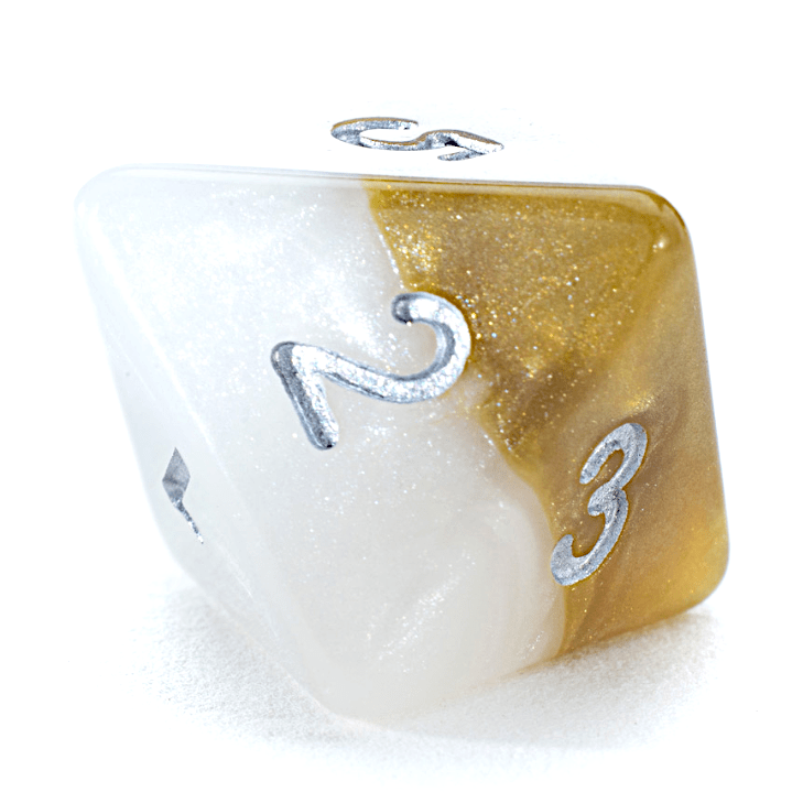 A glittery white and gold swirled polyhedral die shows silver numbers 2 and 3 on its visible faces.
