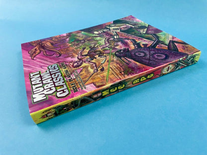 Mutant Crawl Classics RPG rulebook on blue. Its colourful cover art shows a warrior fighting creatures and a large bug