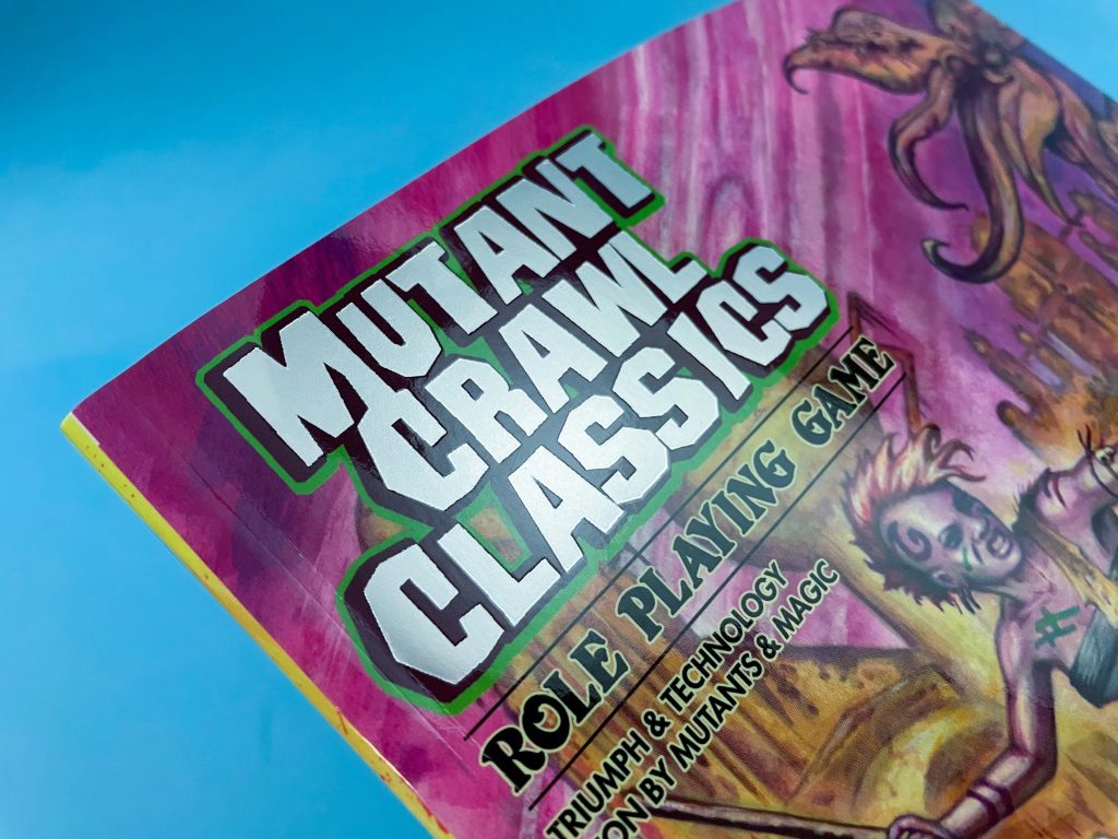 Cover of Mutant Crawl Classics RPG, featuring a tentacled monster and a tribal mutant character