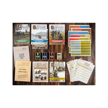 Fields of Fire board game set: rulebooks, counter sheets, and card decks arranged on a wooden table