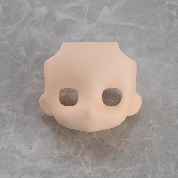 Cream face plate viewed from side angle with visible eye details