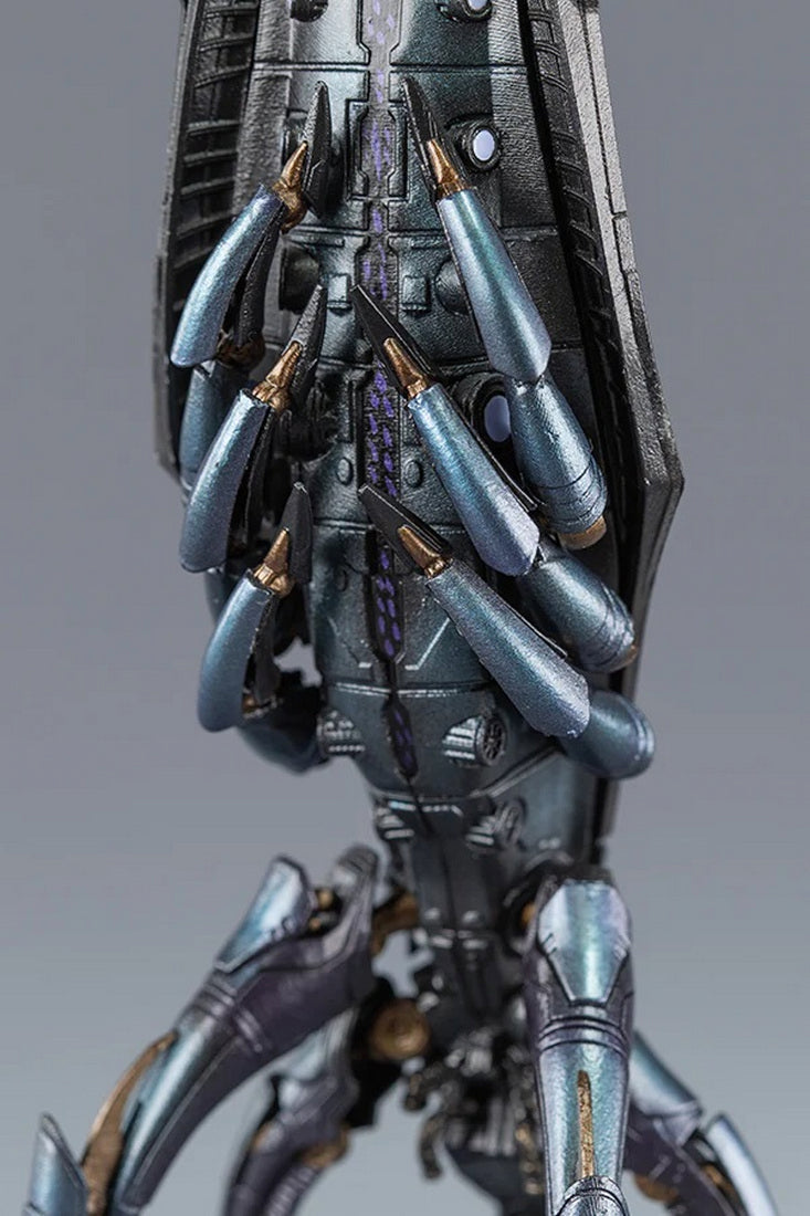 Close-up of a detailed metallic sci-fi model featuring numerous bluish-gray, pointed, weaponized limbs