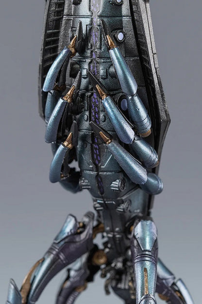 Close-up of a detailed metallic sci-fi model featuring numerous bluish-gray, pointed, weaponized limbs