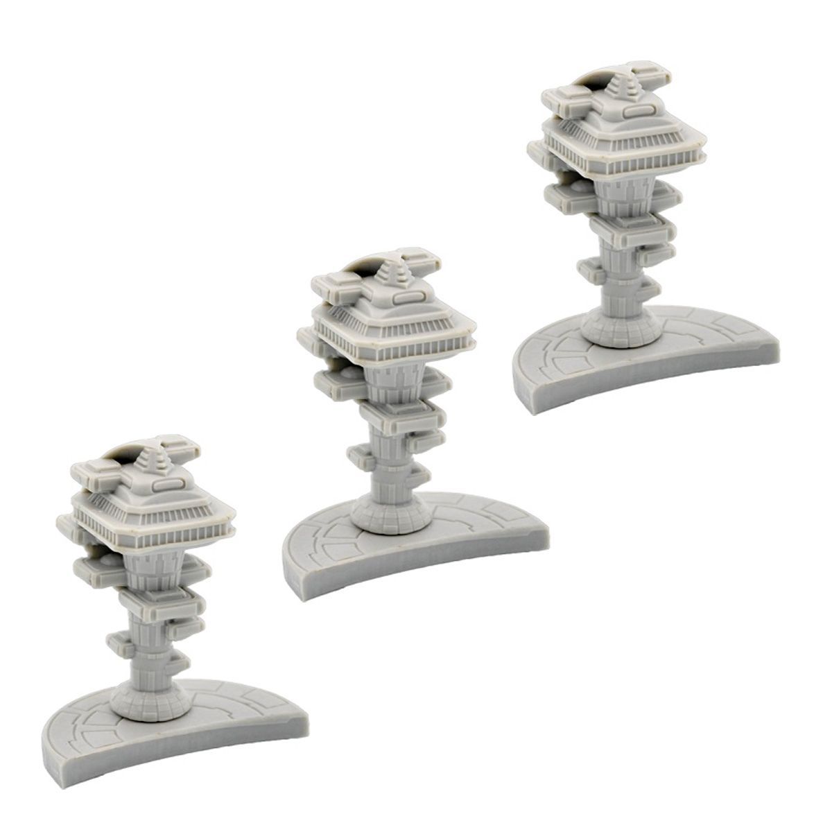 Three identical grey plastic miniature sci-fi towers with tiered levels on curved bases.